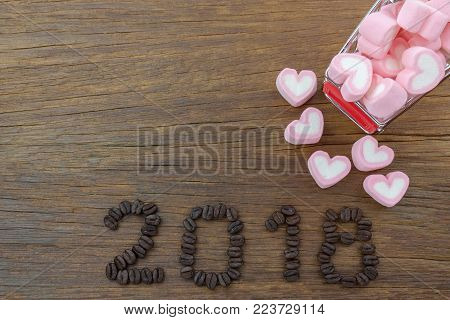 2018 coffee beans and marshmallow  on wood in vintage style for new year concept background