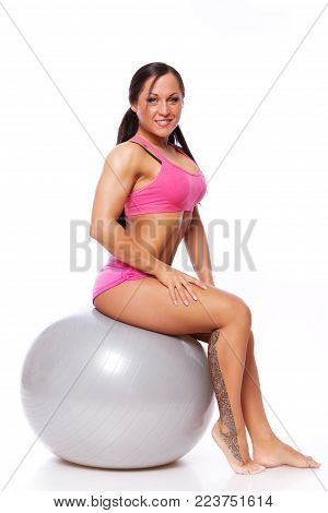 Portrait of joga trainer sitting on fitball