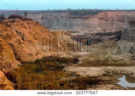 sand mining quarry in Ukraine. deep plumage. sunset in the fog over the quarry