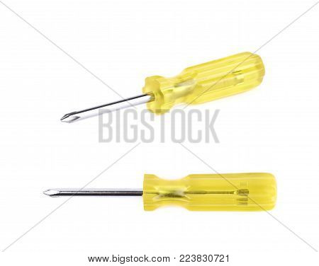 Tiny crosshead screwdriver with a plastic yellow handle, isolated over the white background, set of two different foreshortenings