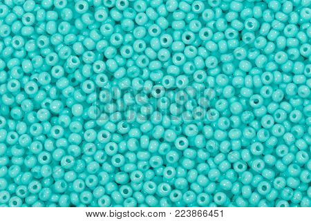 Background of sky blue seed beads. High resolution photo.