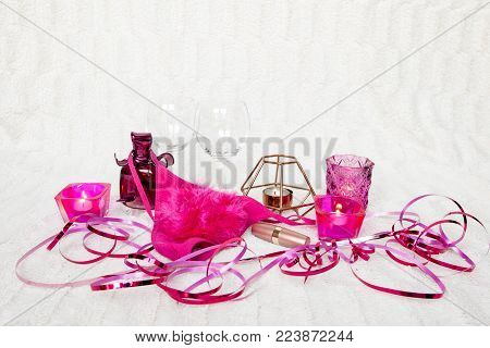 Valentines Day concept. Pink g-strings with wine glasses, roses and candles on white textured background. Isolated.