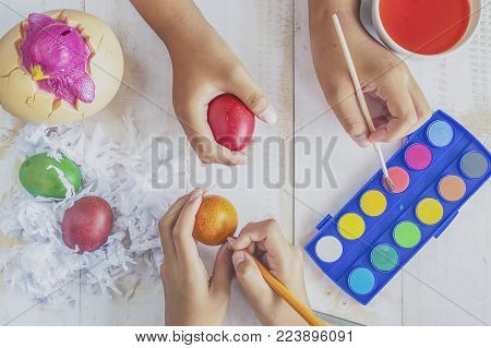 Colouring eggs for eastertime at home their kids painting Easter eggs.Happy easter day.