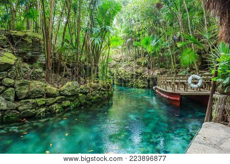 Small river arounded with the rocks in park Xcaret, Mexico