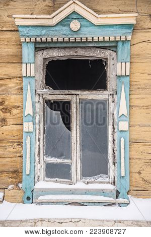 old window with broken glass in an abandoned house