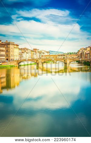 Ponte Santa Trinita bridge over the Arno River with reflections, Florence, Italy, retro toned