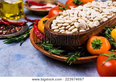 Large white dry beans in a bowl on a white background. Selective focus.
