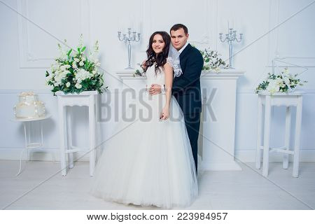 Family studio photography. Wedding photography pair. Husband and wife. Strong black hair and a beautiful blonde.