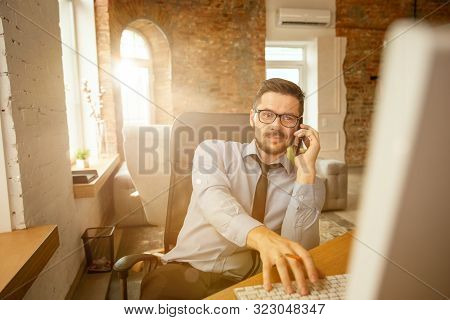 Worktime. A Young Businessman Moving In The Office, Getting New Work Place. Young Male Office Worker