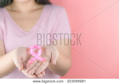 Healthcare, Medicine And Breast Cancer Awareness Concept. Closeup Woman Hands Holding Pink Breast Ca