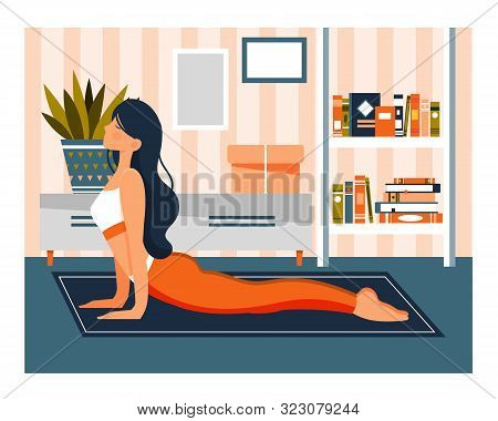 Young Woman Working Out Doing Exercises At Home On A Mat On The Floor In A Healthy Daily Life Concep