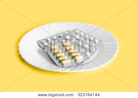 Different Pills On A Plate. The Concept Of Prescription Drugs For Weight Loss. Means For Suppressing