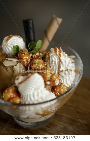Caramel And Almond Ice Cream With Caramelized Popcorn Sundae Dessert In Glass Bowl