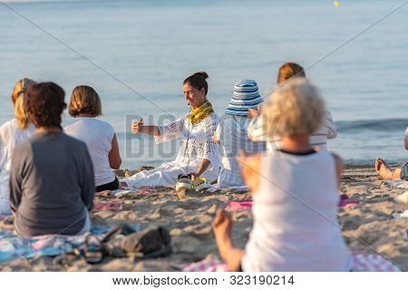 Altafulla, Tarragona, Spain : 219 August 31 :  Yoga Instructor Leading A Group Session At Sunset On 