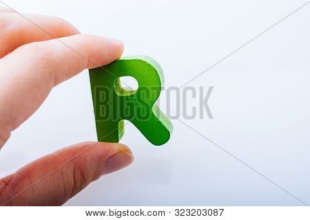 Hand Holding Letter Cube R Of Made Of Wood