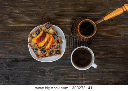 Chocolate Belgian Waffles With Fruits, Cup Of Coffee And Cezve On Wooden Background. Delicious Break