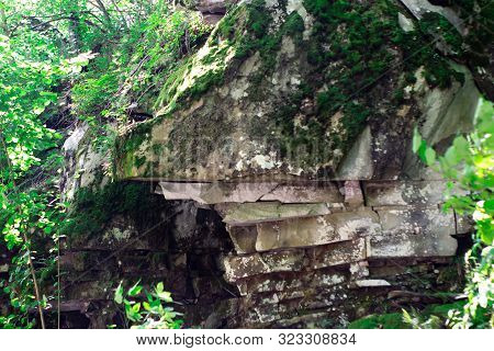 Beautiful Bright Green Moss Grown Up Cover The Rough Stones And On The Floor In The Forest. Show Wit