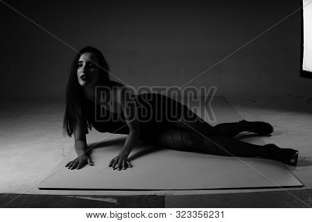 A Young Woman In A Short Turquoise Dress Walking .