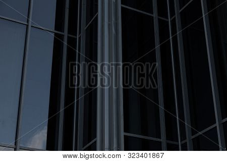 Closeup Of Black Mirrorlike Building Wall Reflecting Sky