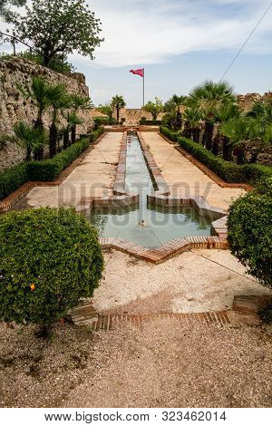 Xativa, Valenciana, Spain - Sept 17 2019 : Ornamental Garden Of Xativa Large Castle With Fountains