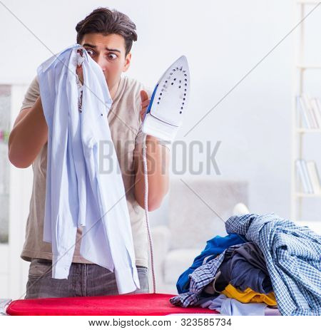 Inattentive husband burning clothing while ironing