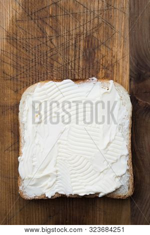 Slice of toast bread with butter spread shot from above