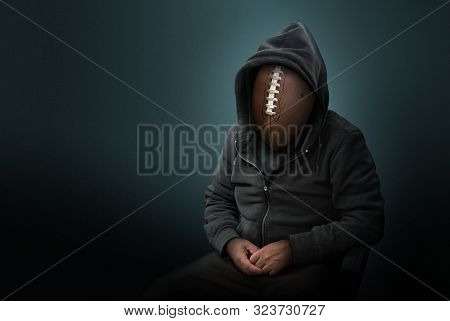 American Football As The Head On Man Wearing A Hoodie