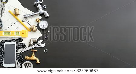 Mobile Phone With Plumbing Items On Dark Background