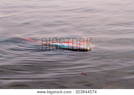 River Fishing Boat Sunk In The River. Sunken Boat In Dirty Water. Vintage Old Colorful Wooden Boat S