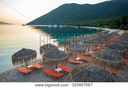 Summer Sunny Morning Sunbeds And Umbrellas Of Amazing Antisamos Beach On The Kefalonia Island, Ionia