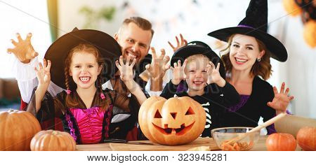 Happy Family Mother Father And Children In Costumes   On A Celebration Of Halloween