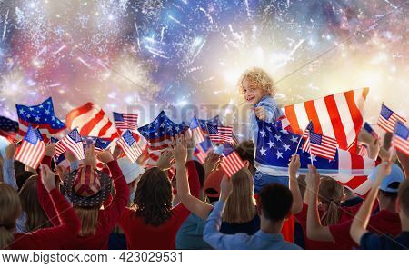 American Family Celebrating 4th Of July. People Watching Independence Day Fireworks Holding Us Flag.