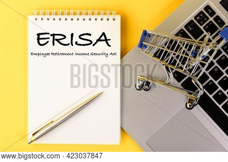 A Paper With The Erisa Employee Pension Law On Lies On A Table With A Laptop, On A Yellow Background