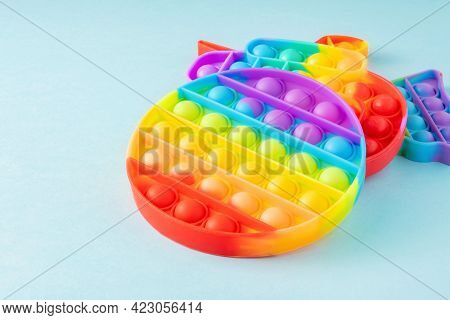 Colorful Silicone Sensory Toys Poppit On Blue Background With Copy Space. Trendy Play For Fidget Chi