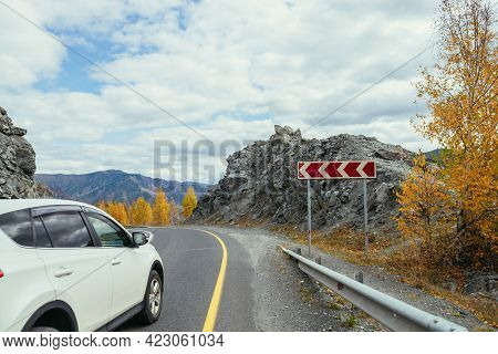 Car On Mountain Highway Between Rocks And Trees With Yellow Foliage In Autumn. Vivid Landscape With 
