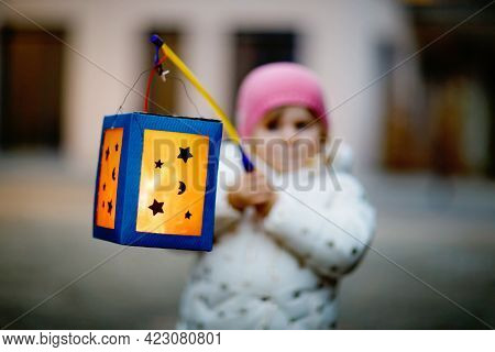 Close-up Of Little Kid Girl Holding Selfmade Lanterns With Candle For St. Martin Procession. Healthy