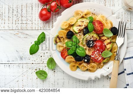 Pasta Fiocchi Salad With Vegetables Grilled Zucchini, Cherry Tomato, Olives, Basil And Parmesan Chee