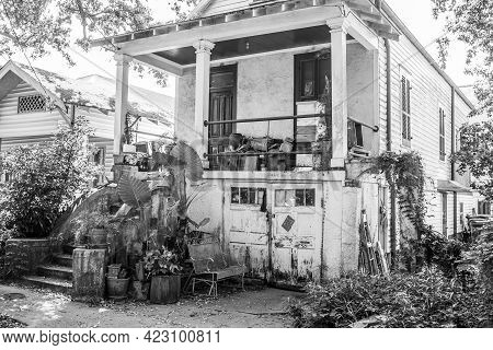 New Orleans, La - May 30: Old Worn Uptown House With Cluttered Front Porch And Yard In Black And Whi