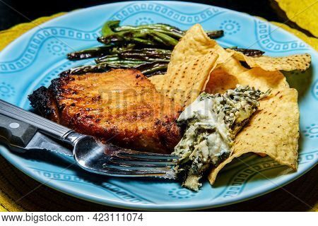 Marinated Char-grilled Pork Chops With Green Beans And Artichoke Spinach Dip