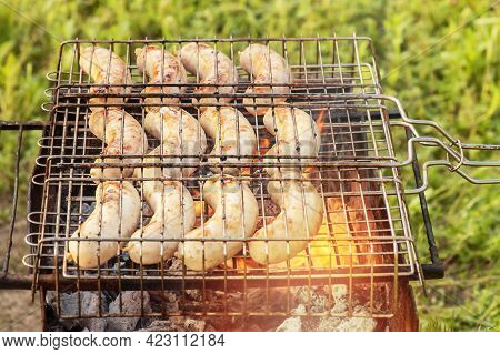 Summer Picnic. Grilled Sausages Are Fried On A Wire Rack.