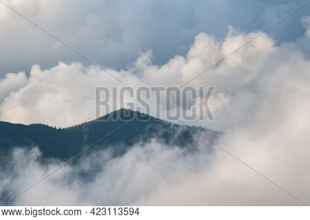 Low Clouds And Mountains Silhouettes. Picturecque Mountain Landscape After The Rain