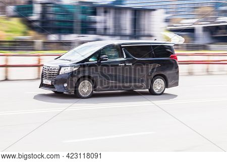 Moscow, Russia - April 2021: Fast Moving Toyota Alphard On The City Road. Black Van Rides On Street.