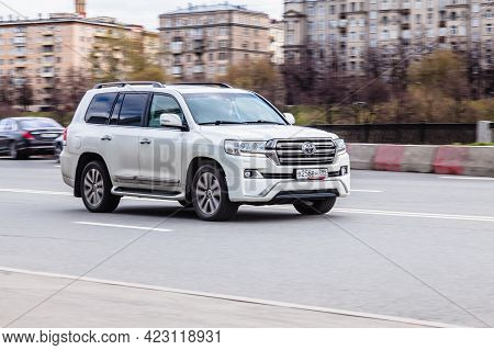 Moscow , Russia - April 2021: Toyota Land Cruiser 200 Rides On The Road. White Premium Suv On The Ci