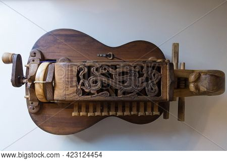 A Brown Wooden Hurdy-gurdy (wheeled Lyre) With An Ancient Dragon Pattern Carved On The Keyboard Cove