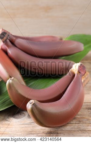 Delicious Red Baby Bananas On Wooden Table