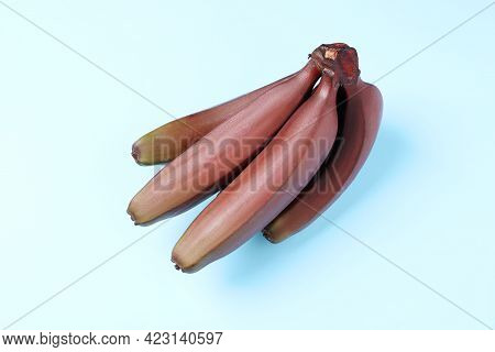 Tasty Red Baby Bananas On Light Blue Background, Top View