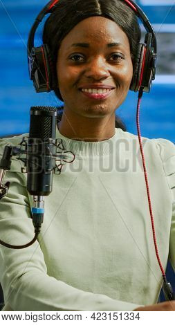 Portrait Of African Smiling Blogger Looking At Camera Before Starting Live Video From Home Studio Po