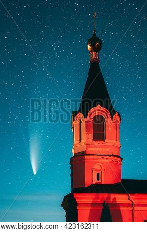 Korma Village, Dobrush District, Belarus. Comet Neowise C2020f3 In Night Starry Sky And St. John The