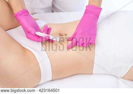A Doctor Of Aesthetic Cosmetology Makes Lipolytic Injections To Burn Body Fat On A Woman’s Stomach A