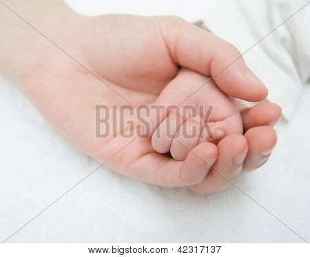 Újszülött baba kezét, egy női kéz